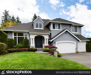 Clean home with healthy front yard during late spring season . Home and healthy front yard during late spring season