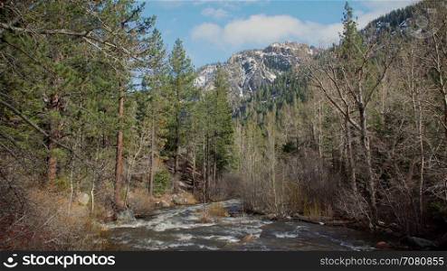 Clean mountain snow water fills a creek in the Sierra Nevada mountain range