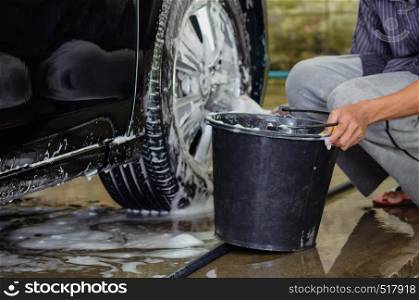 Clean the car wheels with car wash foam and black water tank.