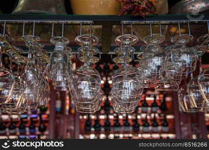 Clean washed glasses. Clean washed glasses hanging over a bar rack