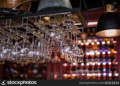 Clean washed glasses. Clean washed glasses hanging over a bar rack