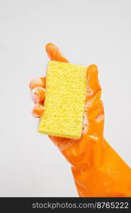 Cleaner concept, Hand in orange rubber gloves and holding yellow sponge with foam for cleaning.