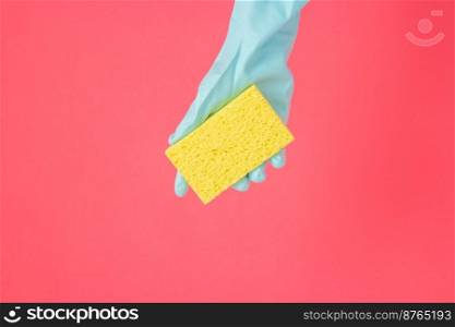 Cleaner concept, Hand in rubber gloves and holding yellow sponge for dishwashing in kitchen.