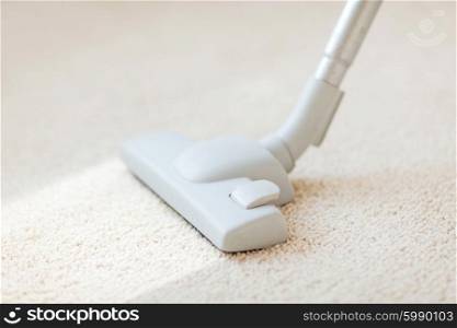 cleaning and home concept - close up of male hoovering carpet. close up of male hoovering carpet