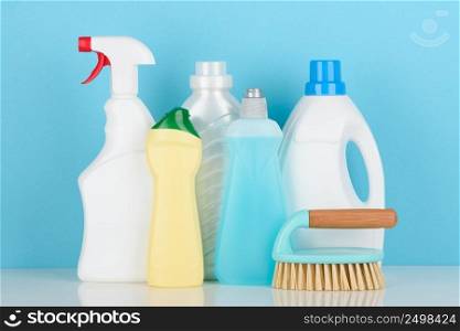 Cleaning liquids and tools set for different housework on white table.