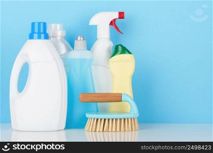 Cleaning product accessories on white table with copy-space.