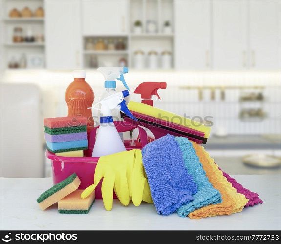 cleaning supplies tools on spring tree bloom over kitchen background, spring clean concept. cleaning supplies tools on plain background