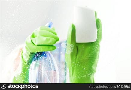 Cleaning window pane with detergent, cleaning concept
