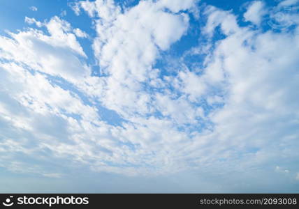 Clear blue sky with white fluffy clouds at noon. Day time. Abstract nature landscape background.