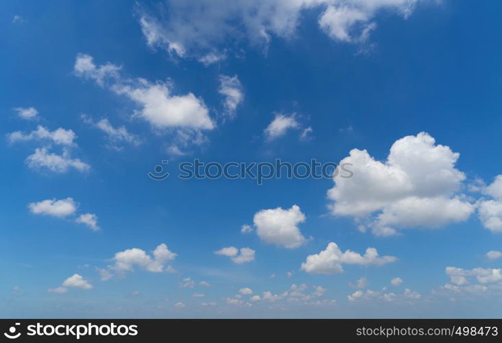 Clear blue sky with white fluffy clouds. Nature background