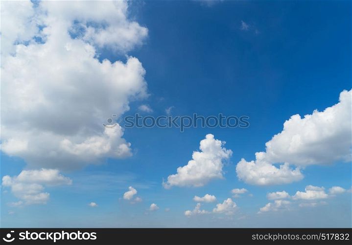 Clear blue sky with white fluffy clouds. Nature background