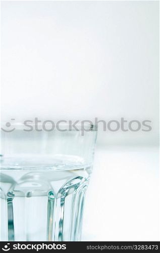 Clear glass of water on white.