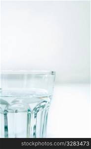 Clear glass of water on white.