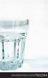 Clear glass tumbler of water.