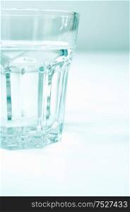 Clear glass tumbler of water.