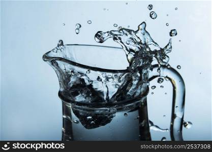 clear jug with splashing water