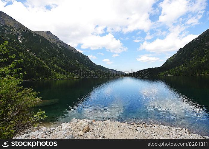 clear lake among mountain ranges