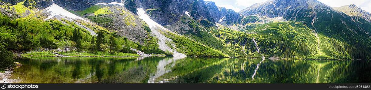 clear lake among mountain ranges
