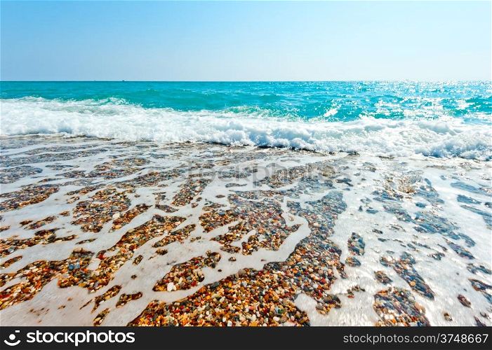 clear sea water and pebble beach