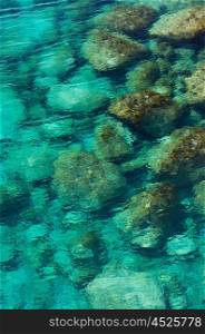 Clear sea water with pebbles