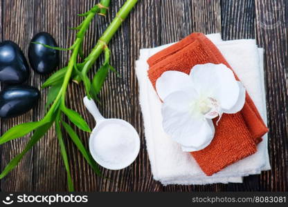 clear towels, black stones and bamboo on a table