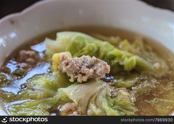 Clear vegetable soup with minced pork close up
