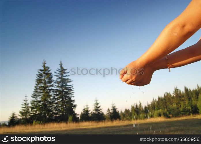 clear water falling on children hands