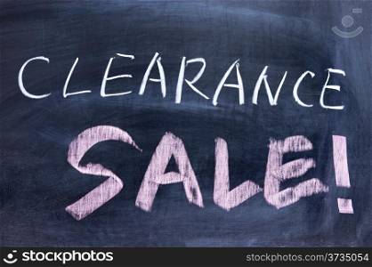 Clearance sale words written on the chalkboard