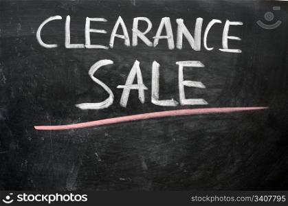 Clearance sale written with chalk on a blackboard