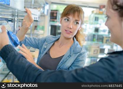 Clerk advising customer in computer shop