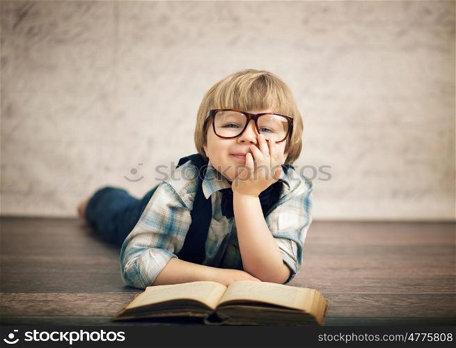 Clever boy reading a book