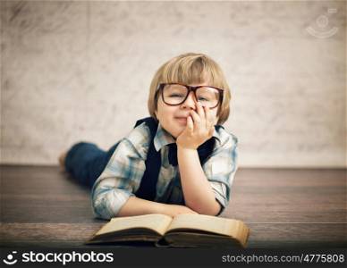 Clever boy reading a book