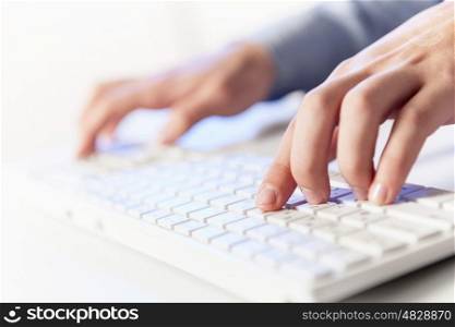 Click! Hands of a man on a keyboard with blue backlighting.