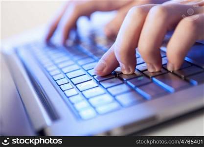 Click! Hands of a man on keyboard. Click! Hands of a man on a keyboard with blue backlighting.