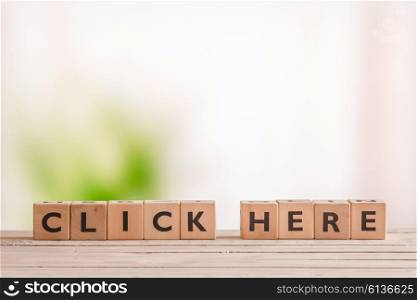 Click here message on a wooden table