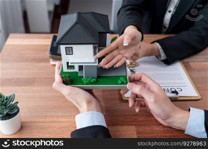 Client and real estate agent review loan contract, discussing term, interest rate, and property ownership. Analyze legal document and thoroughly read agreement before making decision. Jubilant. Client and real estate agent review loan contract and discussing term. Jubilant