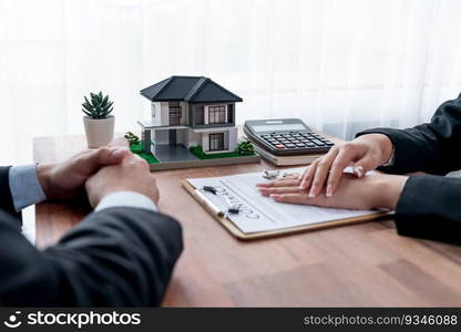 Client and real estate agent review loan contract, discussing term, interest rate, and property ownership. Analyze legal document and thoroughly read agreement before making decision. Jubilant. Client and real estate agent review loan contract and discussing term. Jubilant