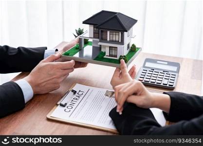 Client and real estate agent review loan contract, discussing term, interest rate, and property ownership. Analyze legal document and thoroughly read agreement before making decision. Jubilant. Client and real estate agent review loan contract and discussing term. Jubilant