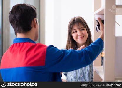 Client getting securty camera installed at home by contractor