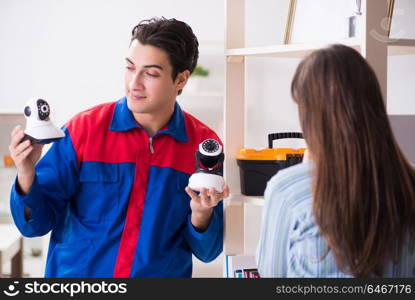 Client getting securty camera installed at home by contractor