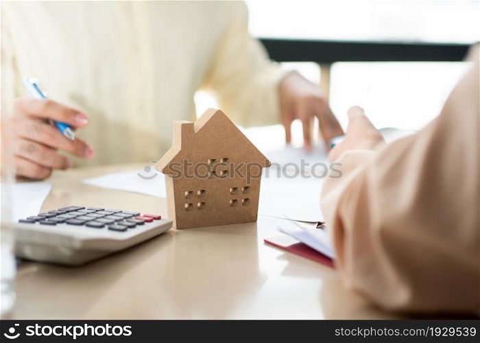 Client signs home loan document to buy homes with real estate property agent or lawyer. Real estate agent and customer signing contract to buy a house. Concept of insurance or loan real estate