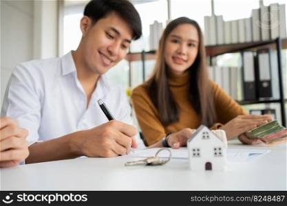 Client signs home loan document to buy homes with real estate property agent or lawyer. Real estate agent and customer signing contract to buy a house. Concept of insurance or loan real estate