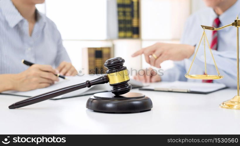 Client with his partner lawyers or attorneys discussing discussing a document or contract agreement working at table in office, Good service cooperation