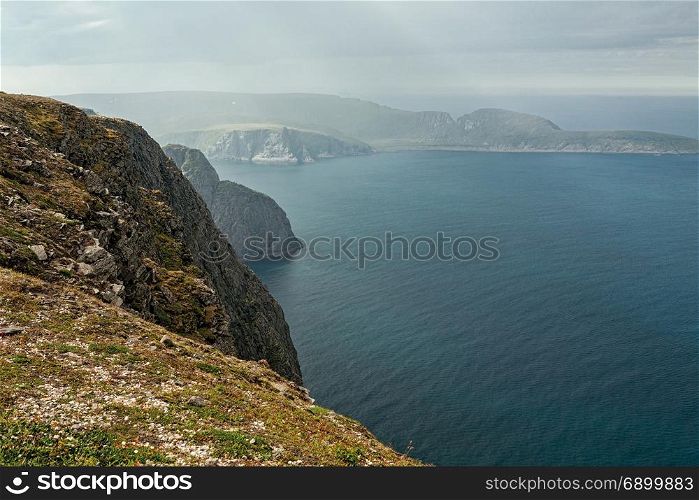 Cliff and ocean in North Cape in Mageroya island, the most northerly point of Europe, Norway. North Cape in Mageroya island, Norway