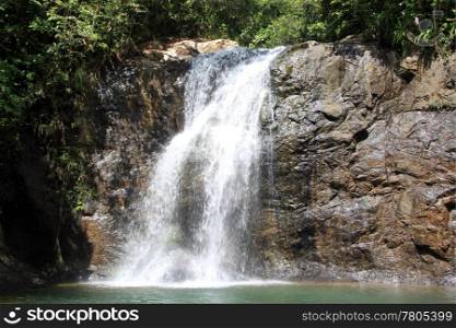 Cliff and small waterfall with clean water in Fiji