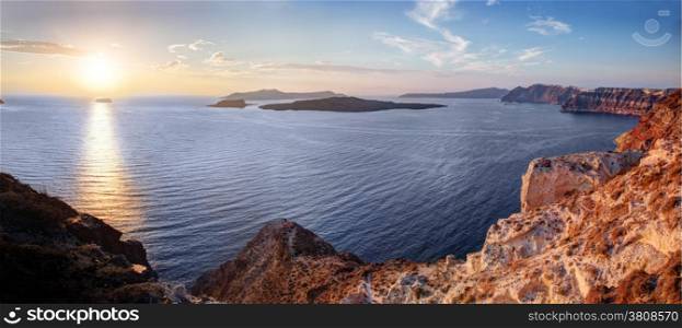 Cliff and volcanic rocks of Santorini island, Greece. View on Caldera and Aegean sea at sunset