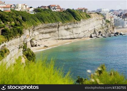 Cliffs at a seaside, Baie De Biarritz, Biarritz, Pyrenees-Atlantiques, France