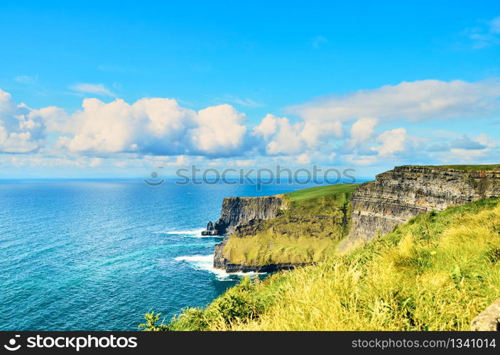 Cliffs of moher in county Clare, Ireland. One of the most popular tourist destinations. Sunny summer day. Cliffs of moher in county Clare, Ireland