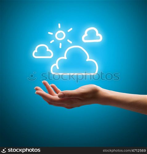 Climate and weather. Close up of human hand holding clouds