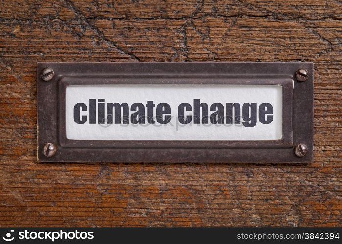 climate change - file cabinet label, bronze holder against grunge and scratched wood